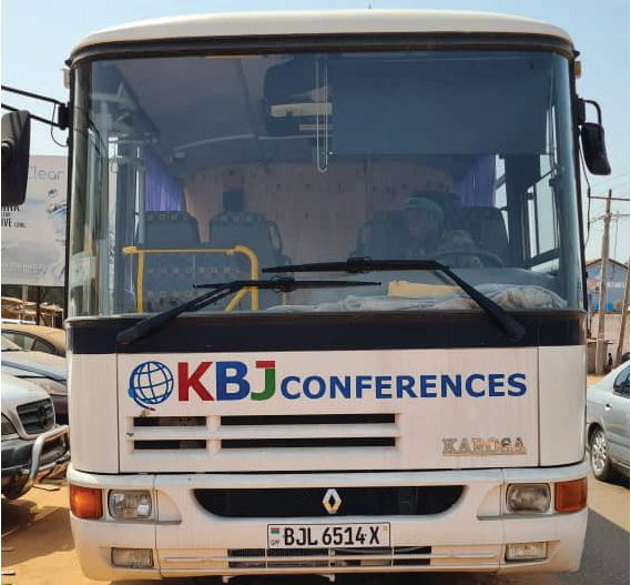 Person placing task list card into walnut card holder next to felt carrying case on leather desk pad.